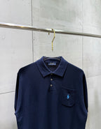 Navy polo sweater front with embroidered logo and buttoned chest pocket