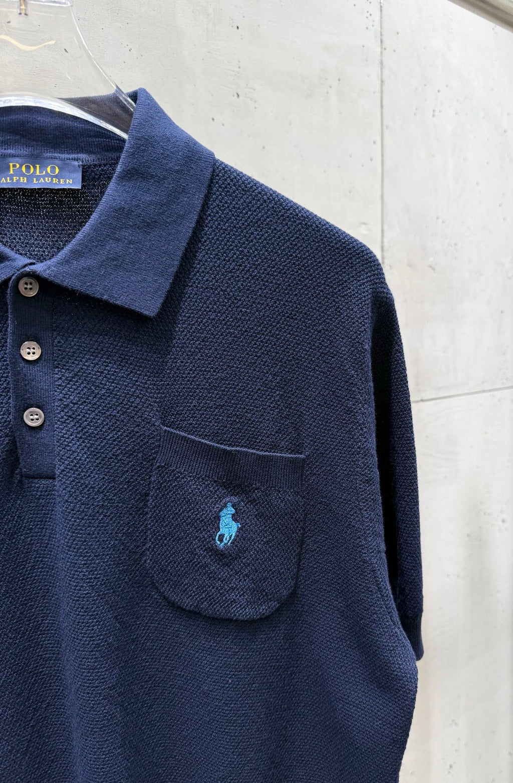 Navy knit polo sweater chest pocket with embroidered logo