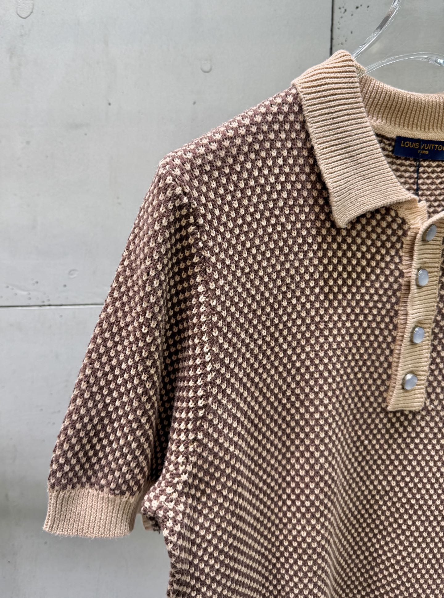 Knit polo shirt sleeve detail, ribbed cuffs, textured pattern knit, partial button placket