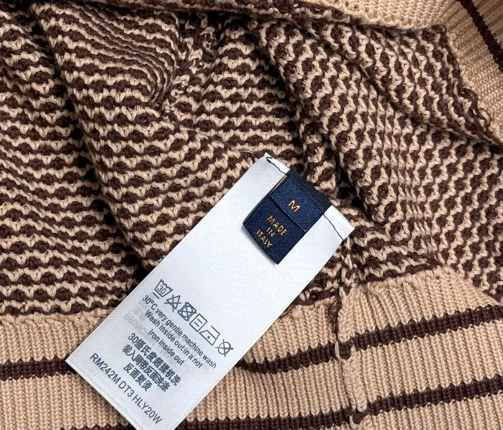 Knit polo shirt care label and size tag on inner hem, striped rib trim