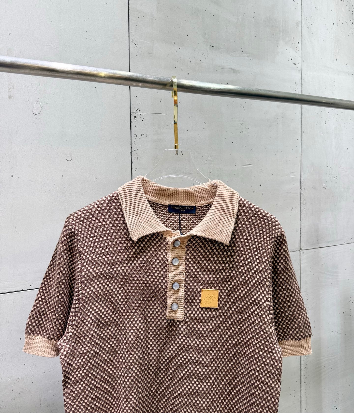 Knit polo shirt with ribbed collar, button placket, small patch at chest, short sleeves