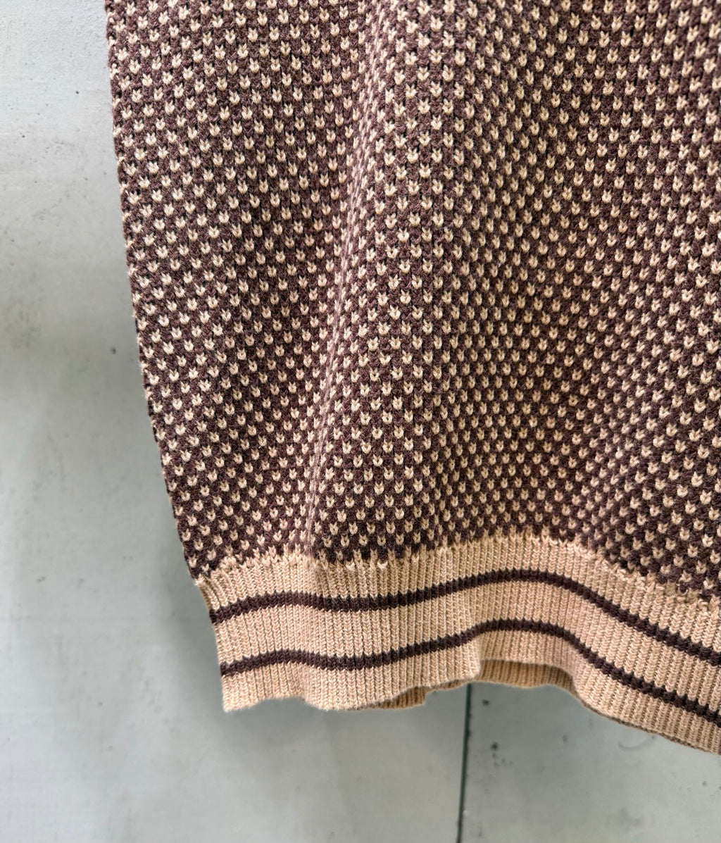 Knit polo shirt hem with striped rib trim, textured pattern knit close-up