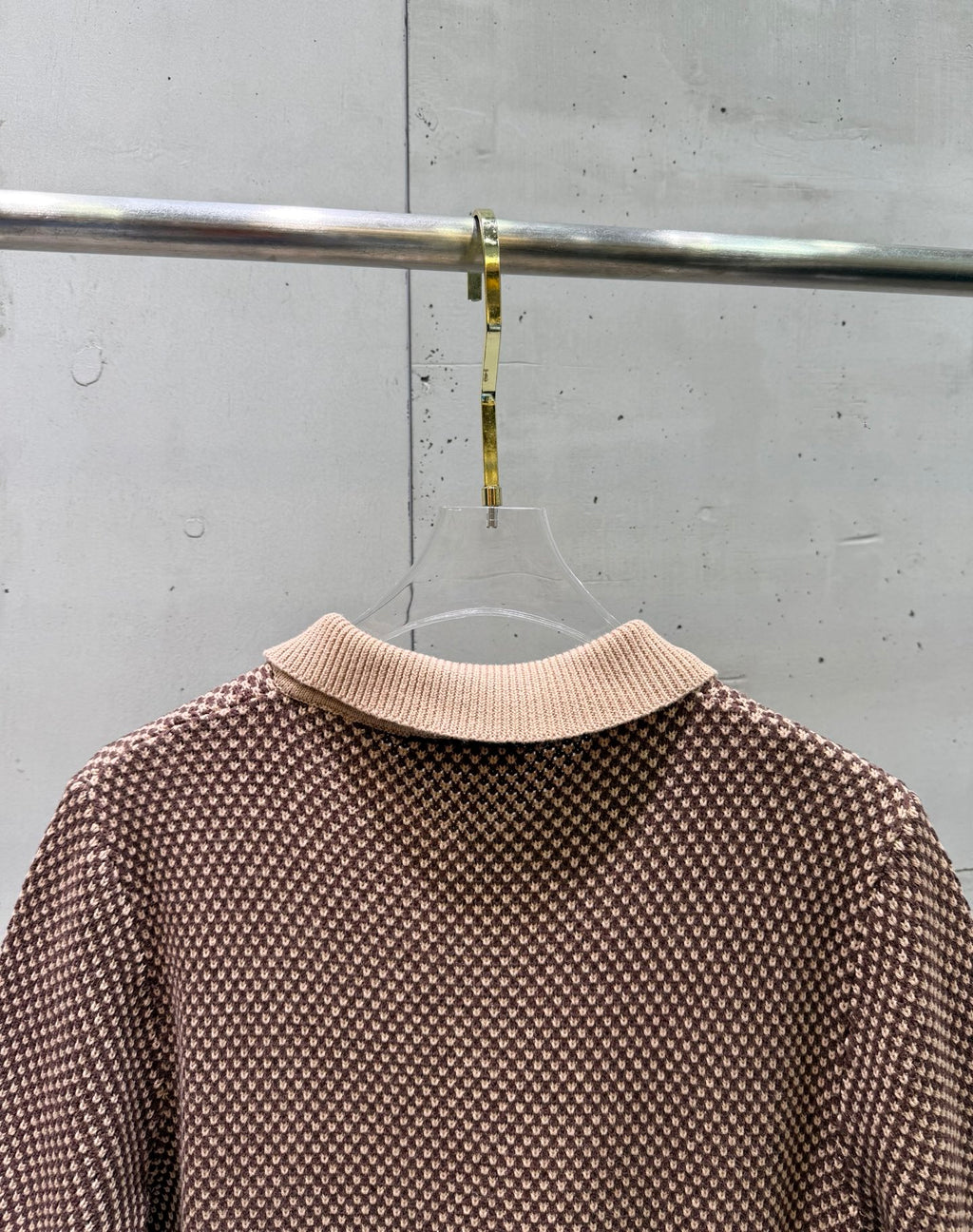 Knit polo shirt, back view, ribbed collar and knit texture with striped hem trim