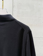 Black polo shirt side view with shoulder seam and sleeve cuff
