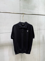 Black short-sleeve polo shirt with button placket and small chest logo