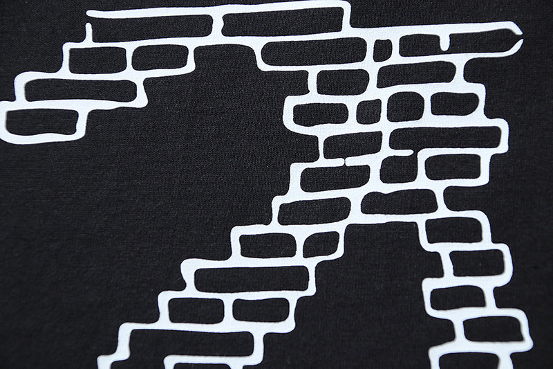 Black T-shirt with large white brick-style X graphic