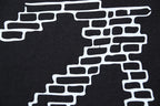 Black T-shirt with large white brick-style X graphic