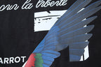 Black T-shirt close-up with blue bird wing graphic and text accents