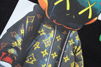 Black T-shirt with character face, colorful star pattern, and zip-like stripes