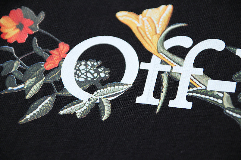 Black T-shirt front with large “off” logo graphic and colorful floral details