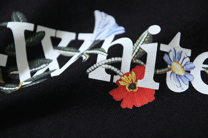 Black T-shirt front graphic with “off” lettering and multicolor flower accents