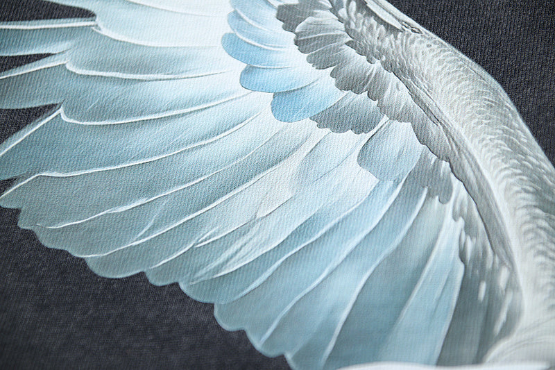 White wing detail graphic on dark T-shirt fabric