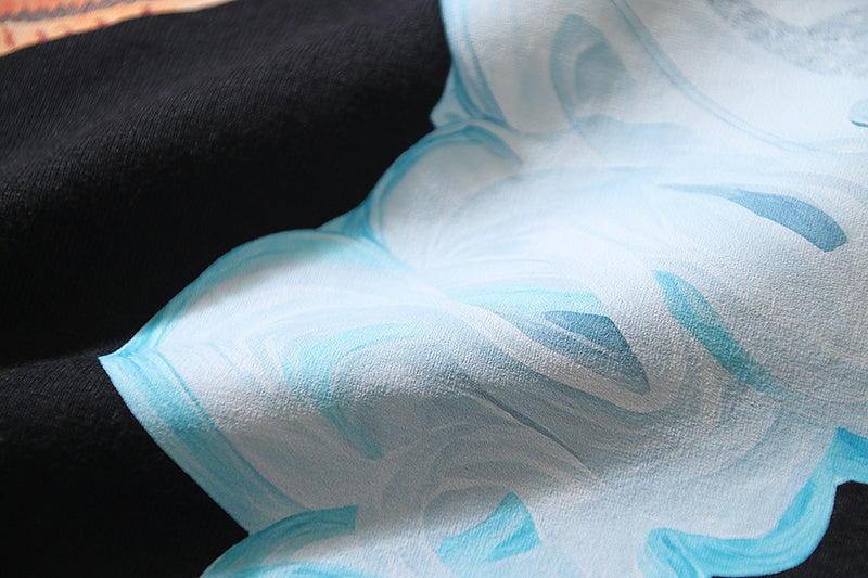 White T-shirt with large blue abstract graphic print near the chest