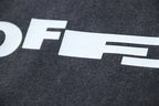 White graphic lettering on dark gray T-shirt fabric close-up
