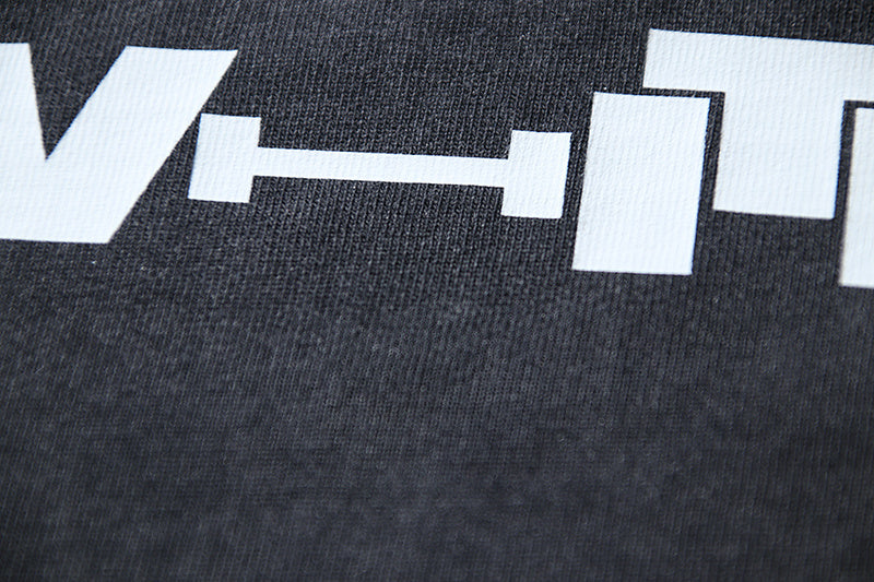 Close-up of white graphic print on dark gray T-shirt