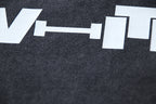 Close-up of white graphic print on dark gray T-shirt