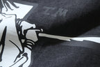 Close-up of white graphic print on dark gray T-shirt fabric