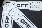 Close-up of white and black Off-White logo graphic on T-shirt front