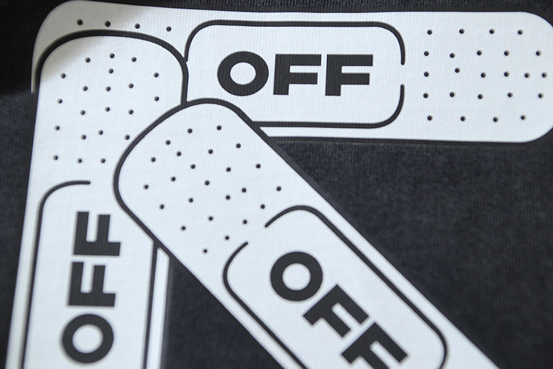 Close-up of white and black Off-White logo graphic on T-shirt front