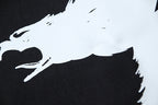 Close-up of bird graphic print on a dark T-shirt