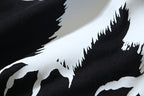 Close-up of bird graphic print in black and white on a dark T-shirt