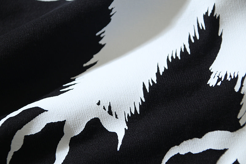 Close-up of bird graphic print in black and white on a dark T-shirt