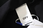 Off-White clothing tag with blue security tag on dark fabric