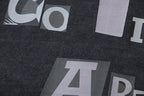 Large white and gray graphic letters on black T-shirt