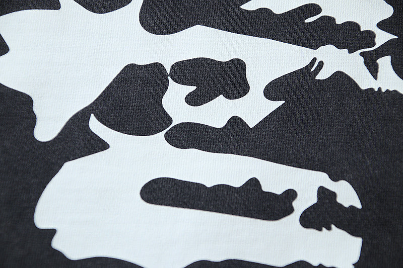 Large distressed silhouettes on light-and-dark graphic print T-shirt