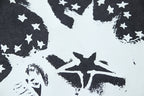 Distressed star-and-figure graphic print on dark crewneck T-shirt