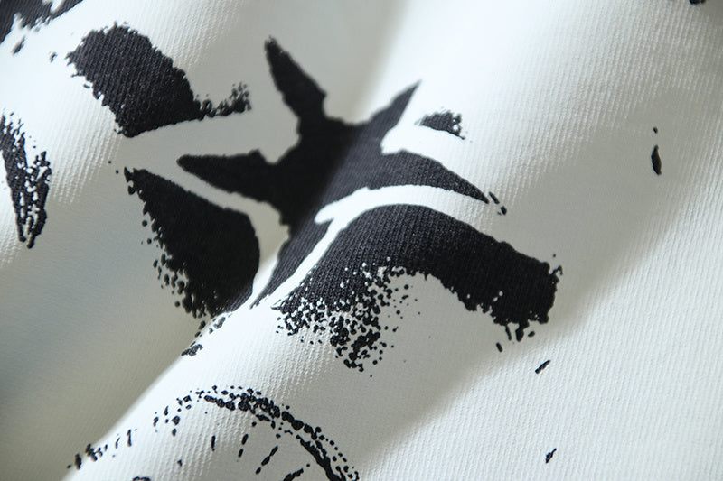 Close-up of white and black distressed graphic print on T-shirt fabric