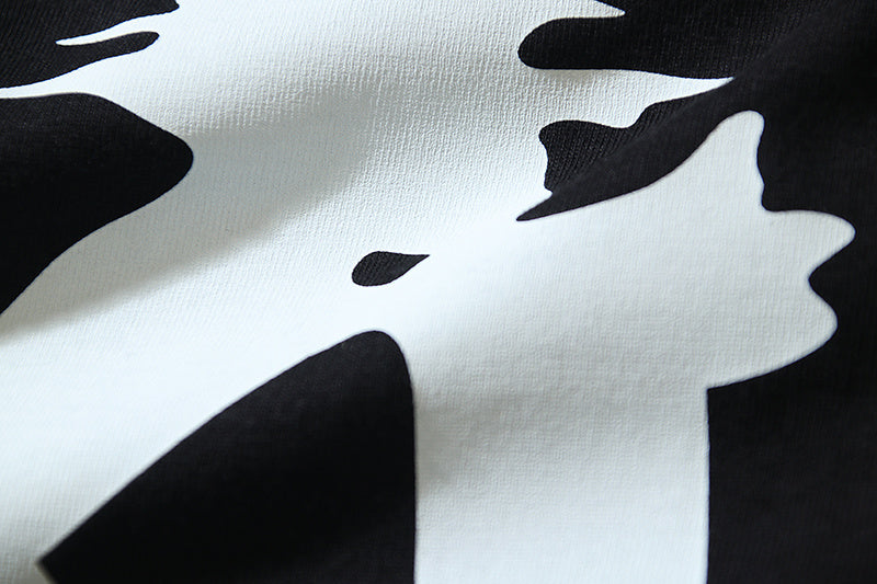 Off-White graphic T-shirt close-up with black starburst silhouettes on off-white