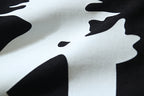 Off-White graphic T-shirt close-up with black starburst silhouettes on off-white