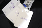 Off White clothing hang tags with Off-White logo on dark fabric