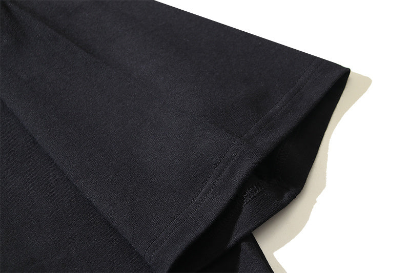 Black T-shirt hem and folded sleeve edge, plain fabric