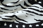Off-White graphic T-shirt detail: black stripes and star pattern on off-white