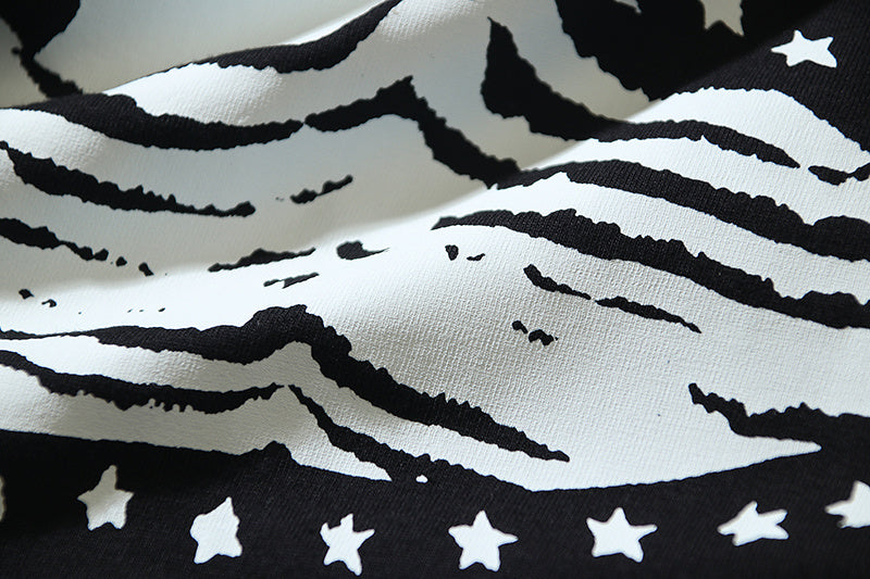 Off-White graphic T-shirt detail: black stripes and star pattern on off-white