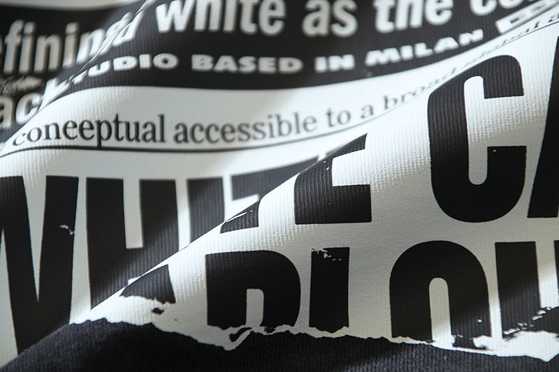Close-up of black T-shirt graphic text with white and black lettering