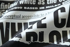 Close-up of black T-shirt graphic text with white and black lettering