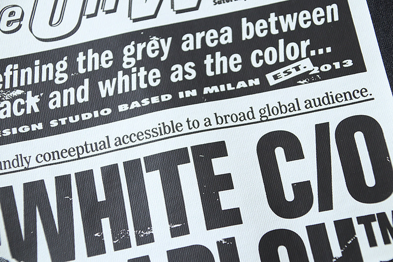 Close-up of black T-shirt graphic typography with large white letters