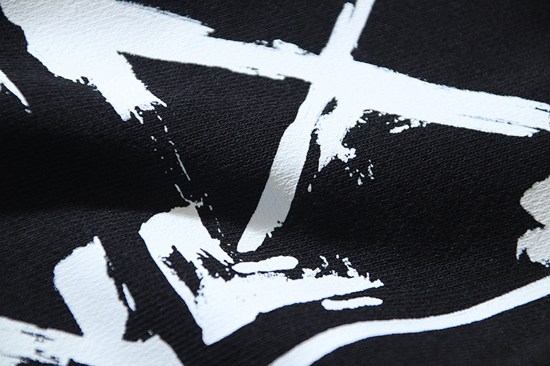 Off-White star and spray graphic print on black shorts fabric