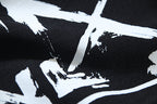 Off-White star and spray graphic print on black shorts fabric