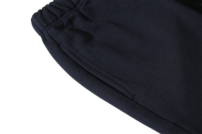 Black shorts hem with curved seam and drawstring waistband