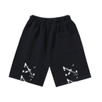 Dark shorts with elastic waistband, drawstring, and white graphic at hem