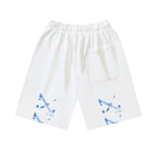 Off-white shorts with elastic waistband, drawstring, side pocket, and blue graphic
