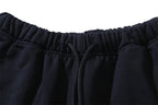 Black drawstring shorts with elastic waistband and gathered fabric