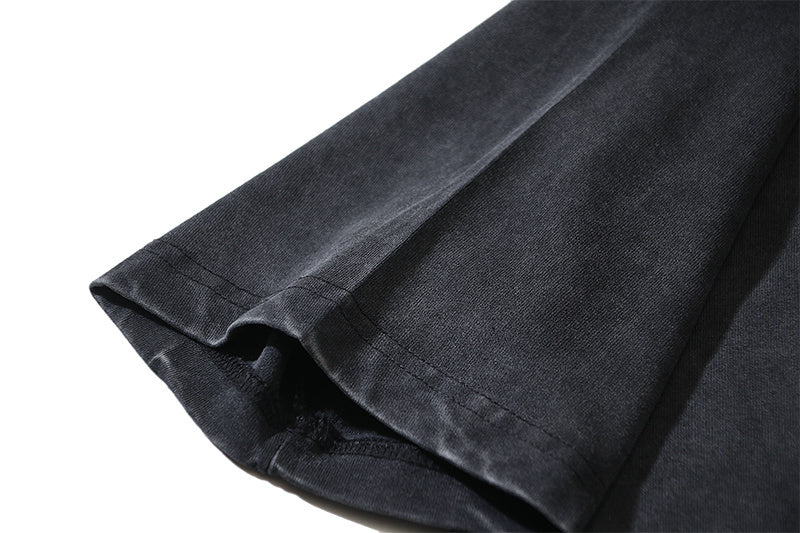 Black T-shirt sleeve and hem, fabric texture visible