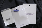 Dark T-shirt with attached Off-White clothing tags