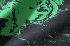 Black T-shirt fabric with green splash print and dotted speckle detail