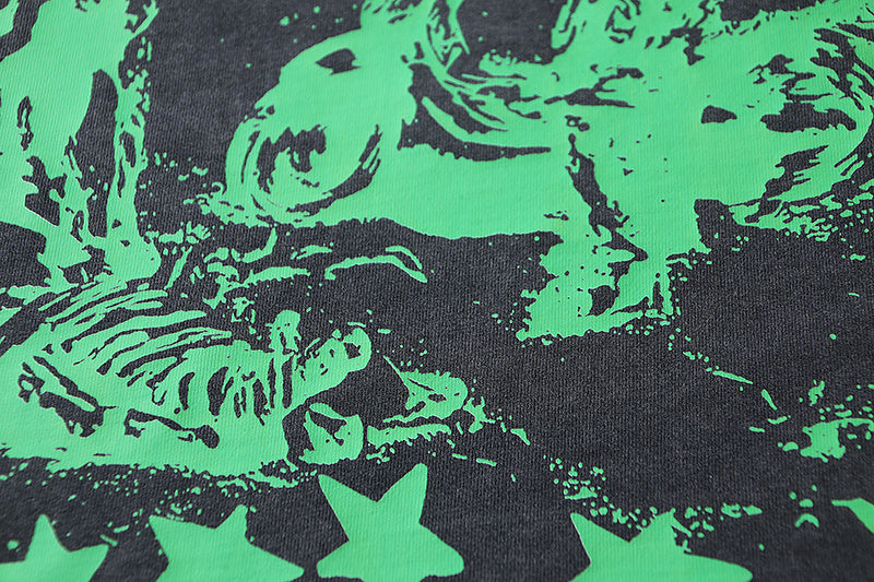 Black T-shirt front print: green illustration with stars and splatter pattern